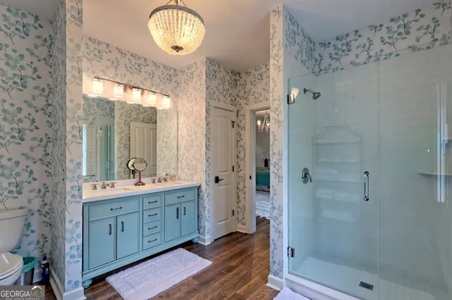 a bathroom with a toilet a sink and a mirror