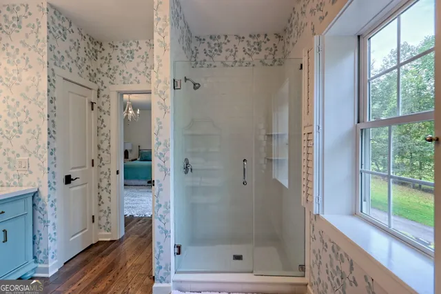 a en suite bathroom with a double vanity sink and a mirror