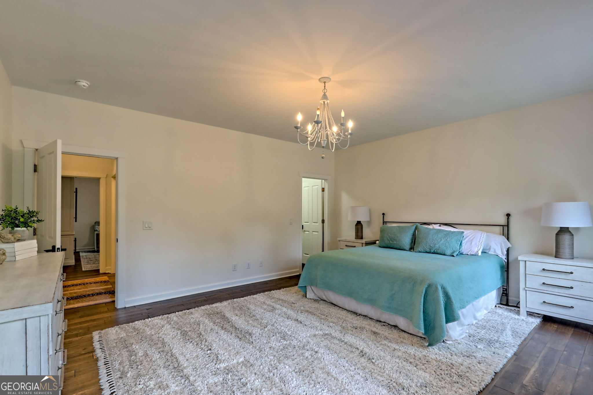 571 Ledford Road Dillard, GA 30537 - Photo 42 of 78 a bedroom with a bed and a chandelier