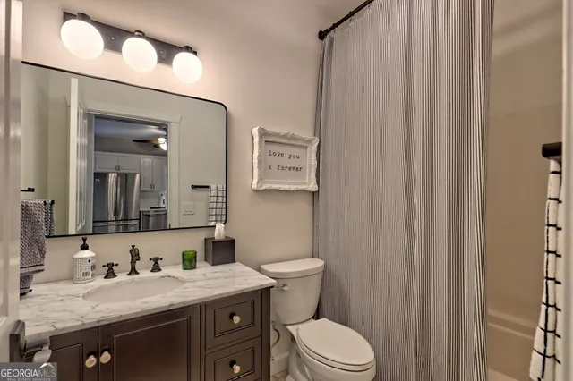 an aerial view of residential houses with outdoor space and trees all around