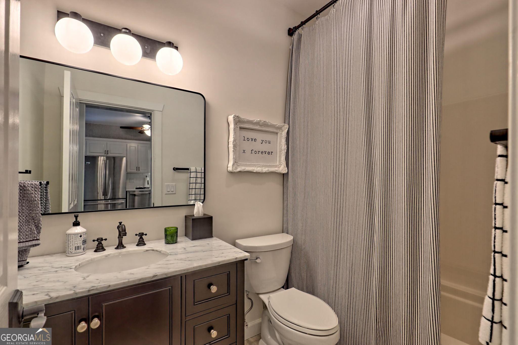 571 Ledford Road Dillard, GA 30537 - Photo 47 of 78 a bathroom with a granite countertop sink vanity mirror and toilet