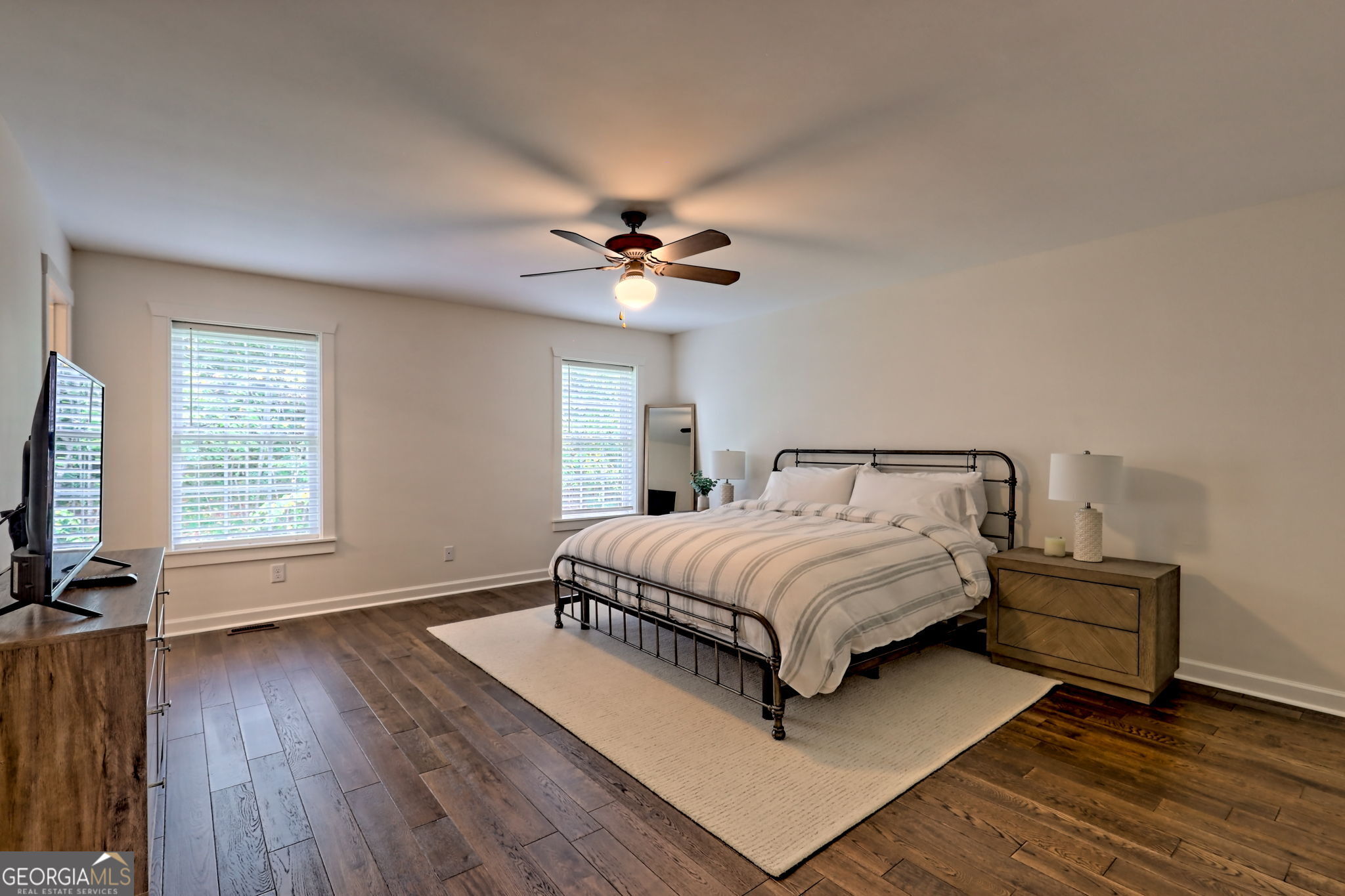 571 Ledford Road Dillard, GA 30537 - Photo 53 of 78 a spacious bedroom with a bed a window and a flat screen tv