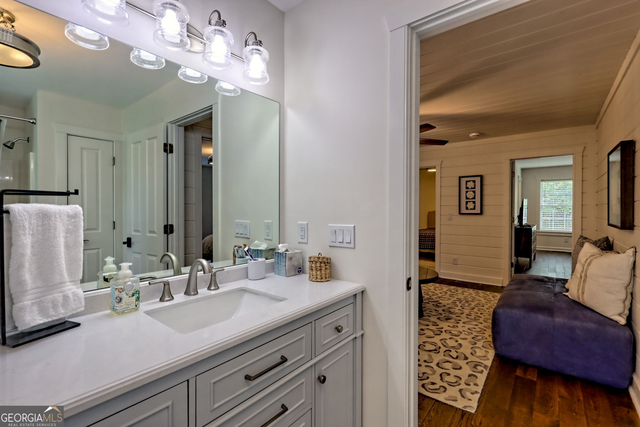571 Ledford Road Dillard, GA 30537 - Photo 61 of 78 a en suite bathroom with a double vanity sink and a mirror
