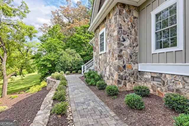 a living room with furniture a chandelier and a fireplace
