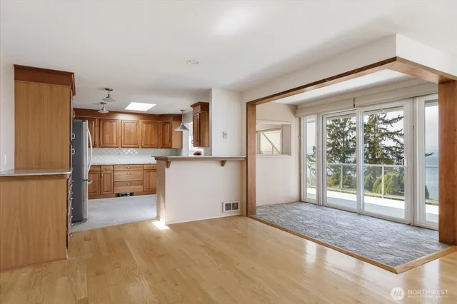 a view of a kitchen with a sink and a refrigerator