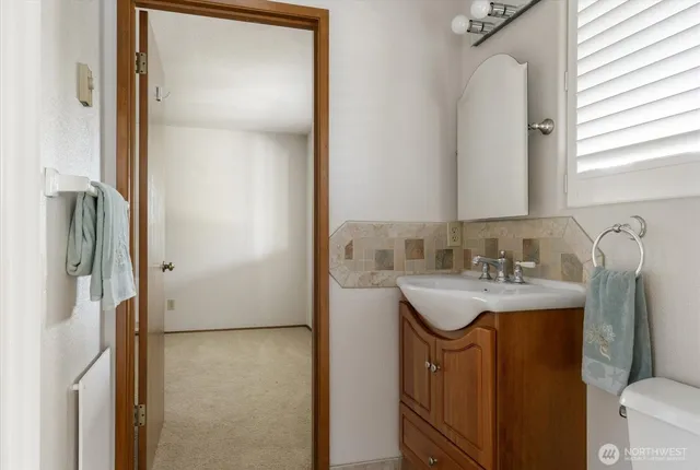 a bathroom with a sink toilet and mirror