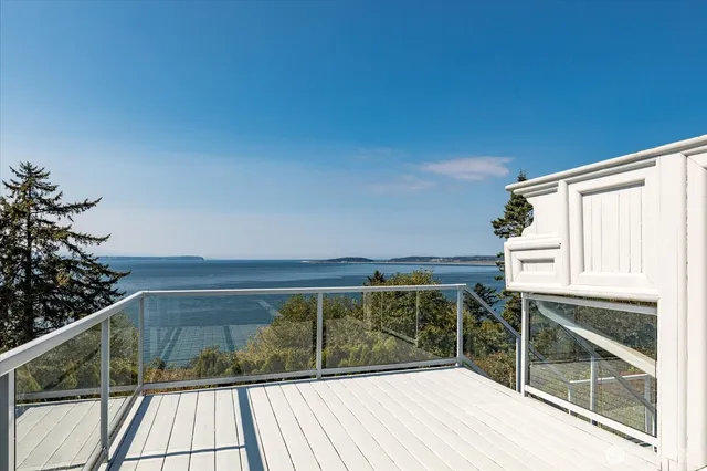a view of balcony with wooden floor and fence