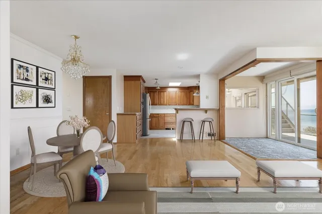 a living room with fireplace furniture dining table and a flat screen tv