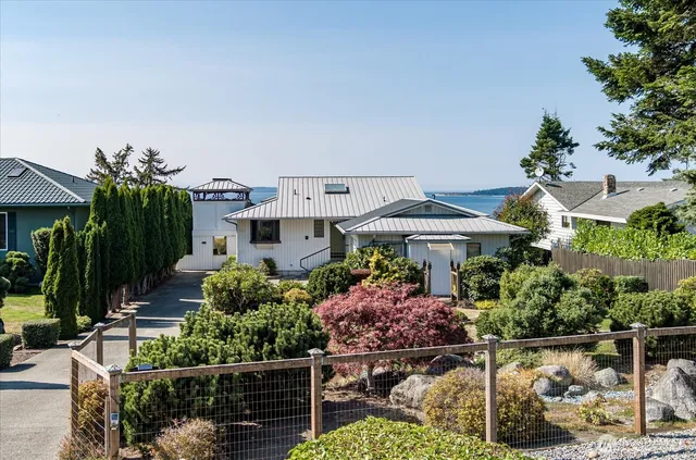 an aerial view of a house with garden space and street view