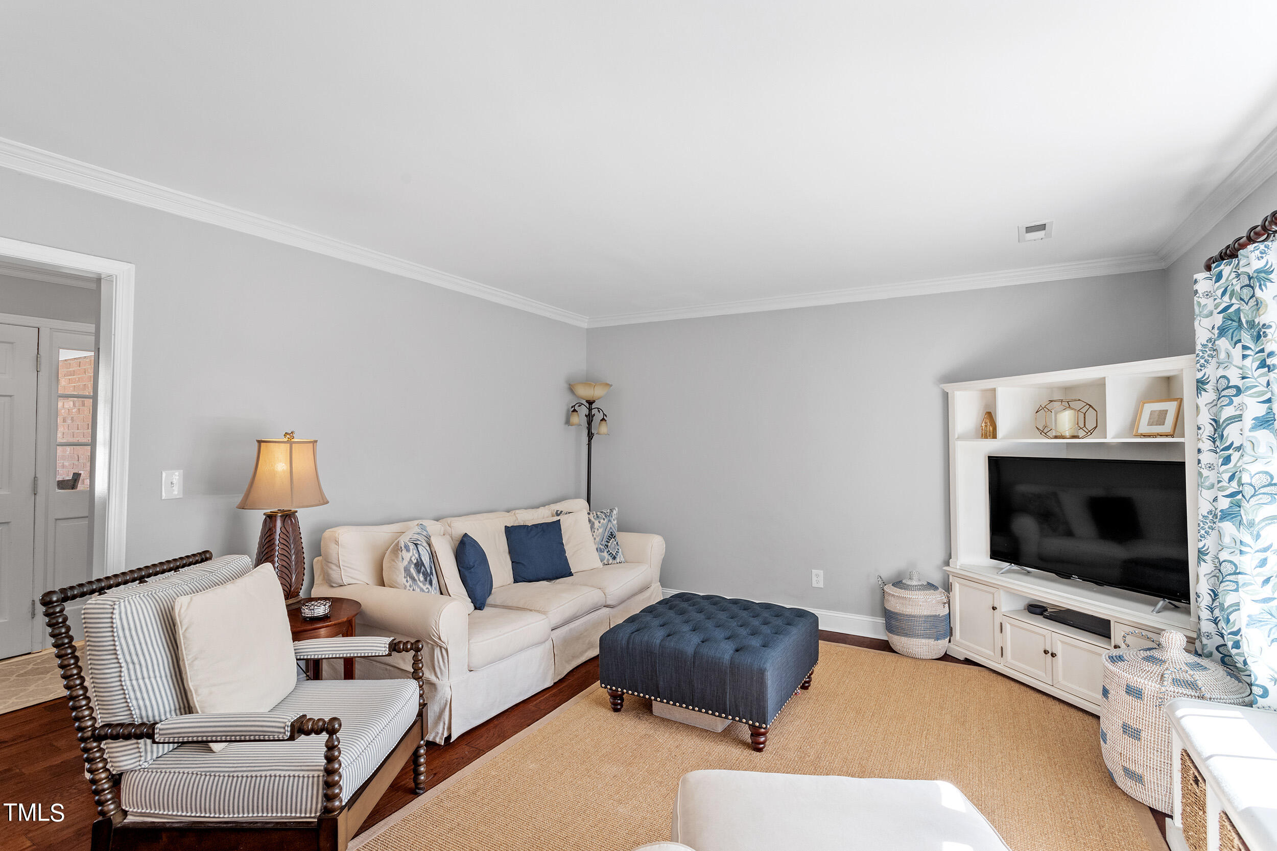 3316 Blue Ridge Road Raleigh, NC 27607 - Photo 6 of 35 a living room with furniture a flat screen tv and a fireplace