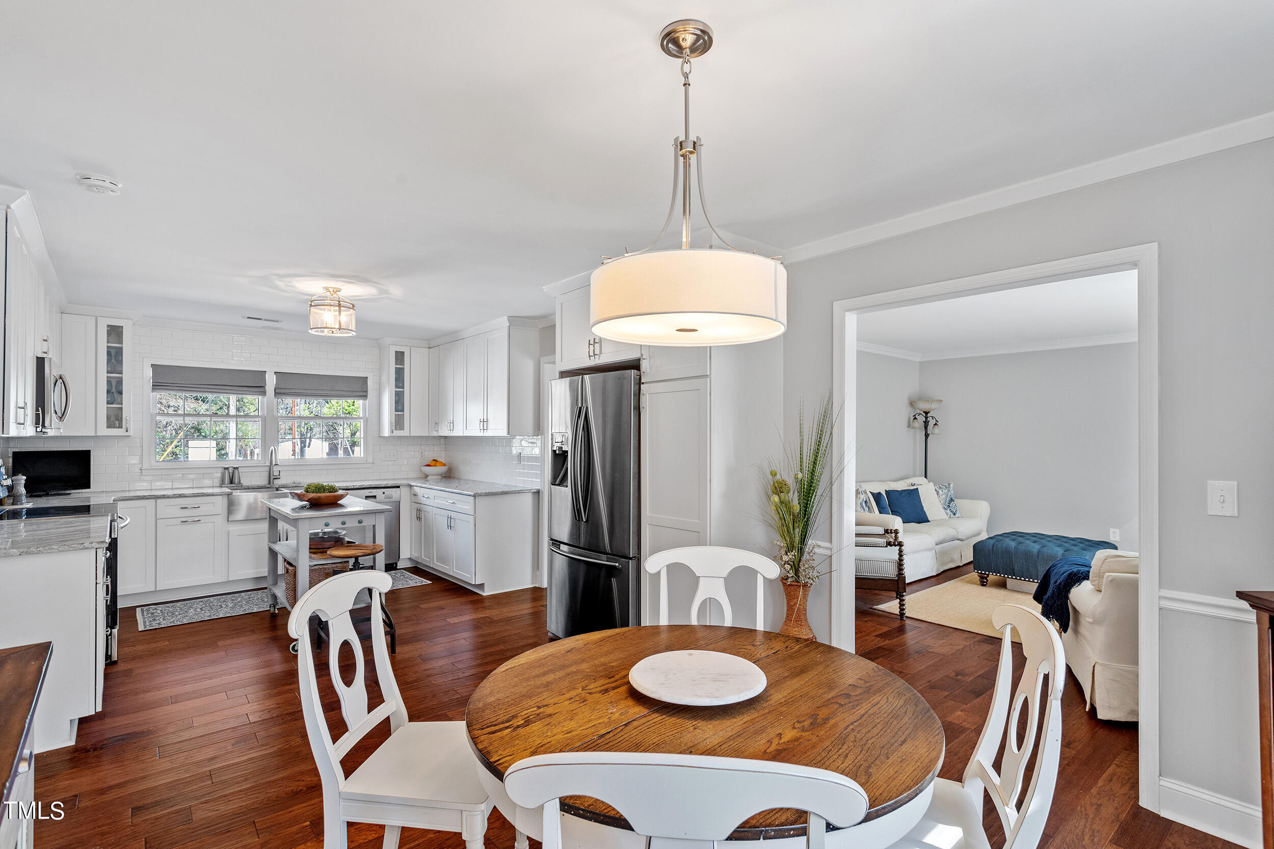 3316 Blue Ridge Road Raleigh, NC 27607 - Photo 9 of 35 a view of a dining room with furniture a kitchen and chandelier