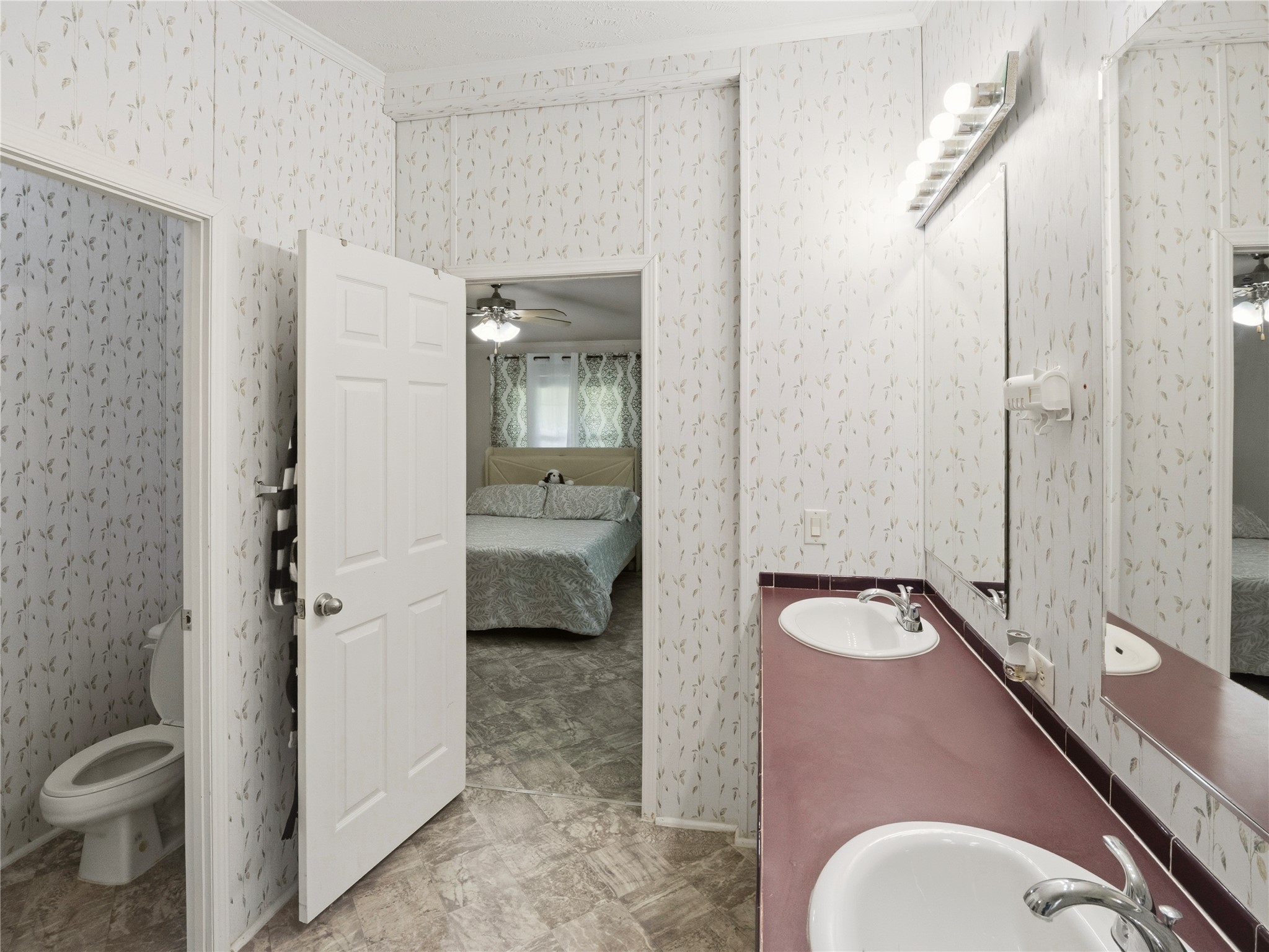 13241 2338th Road Georgetown, TX 78633 - Photo 13 of 26 Double vanities and a private commode offer convenience and functionality in this well-appointed bathroom.