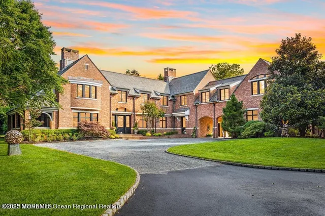 a front view of a house with a garden and patio