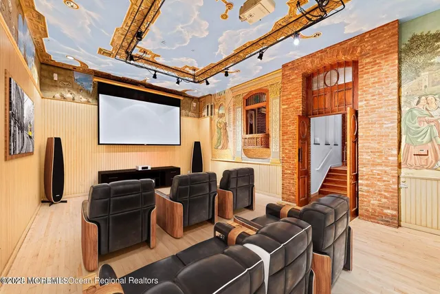 a view of empty room with wooden floor and ceiling fan