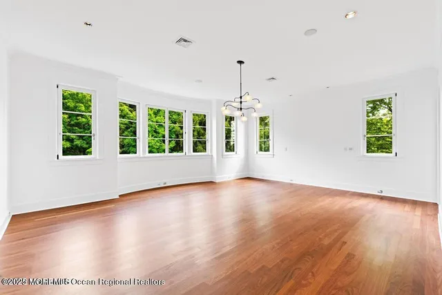 a view of an empty room with a fireplace and a window