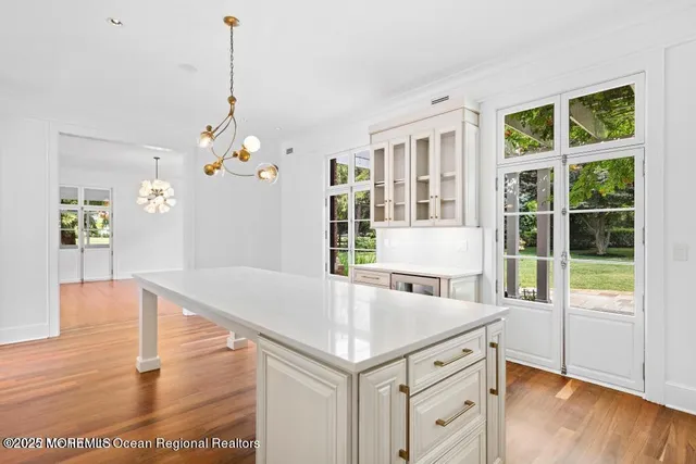 a living room with furniture and view of kitchen