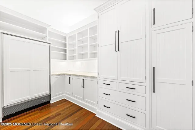 a living room with fireplace furniture and a large window