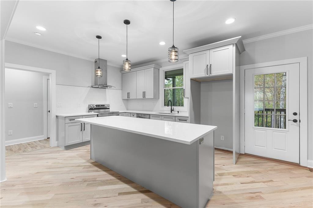 1713 Cagle Court Lawrenceville, GA 30045 - Photo 11 of 50 a large kitchen with cabinets a sink a window and stainless steel appliances