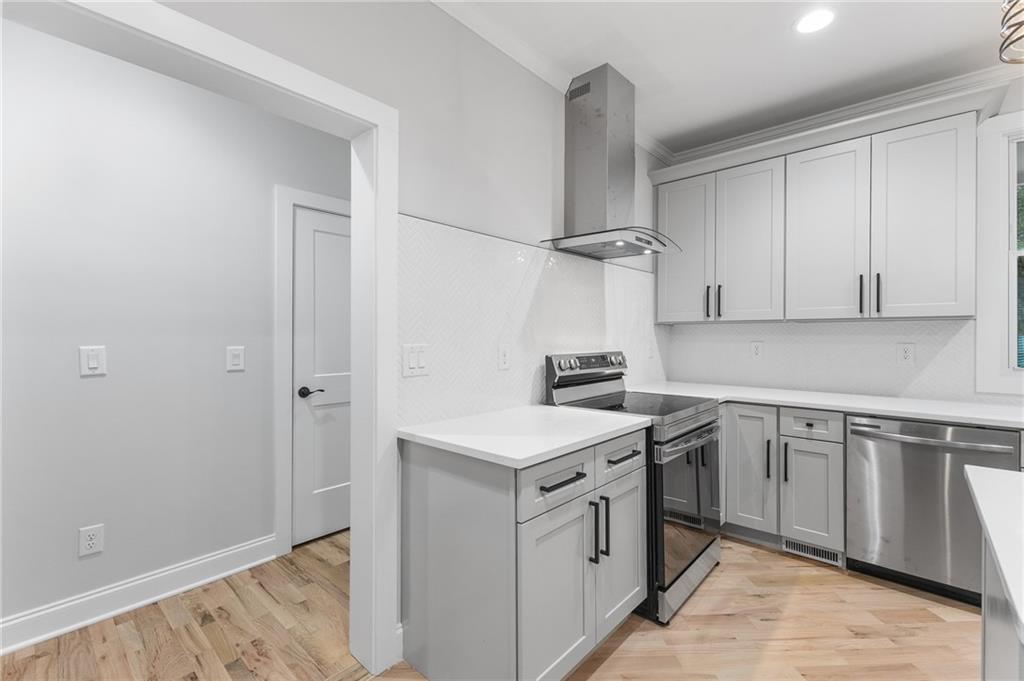 1713 Cagle Court Lawrenceville, GA 30045 - Photo 12 of 50 a kitchen with stainless steel appliances granite countertop a sink stove and refrigerator