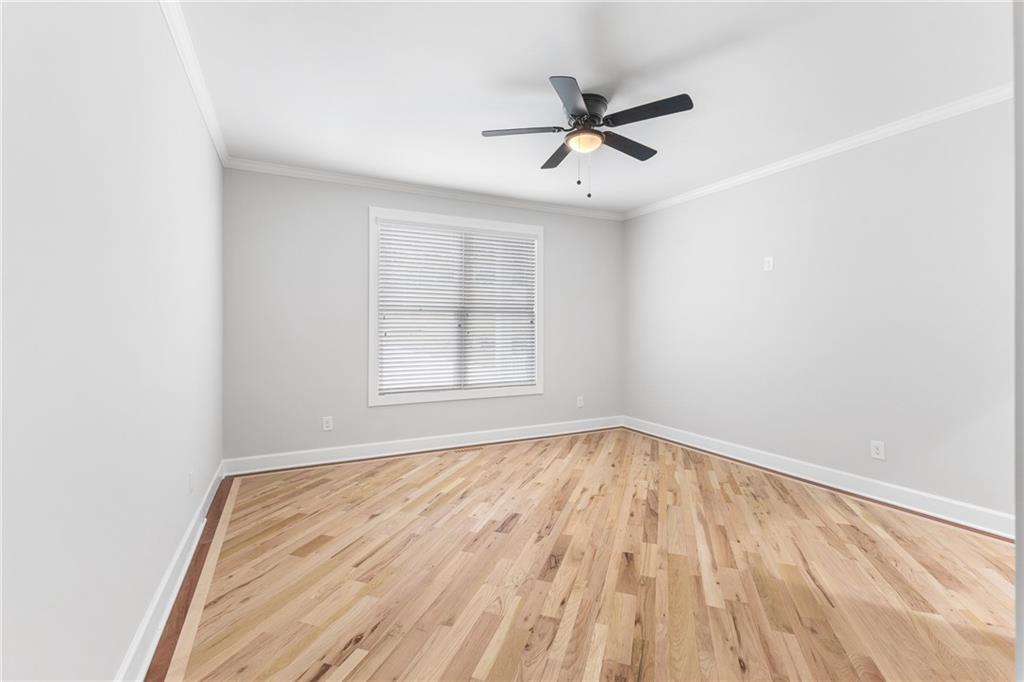 1713 Cagle Court Lawrenceville, GA 30045 - Photo 18 of 50 a view of empty room with wooden floor and fan