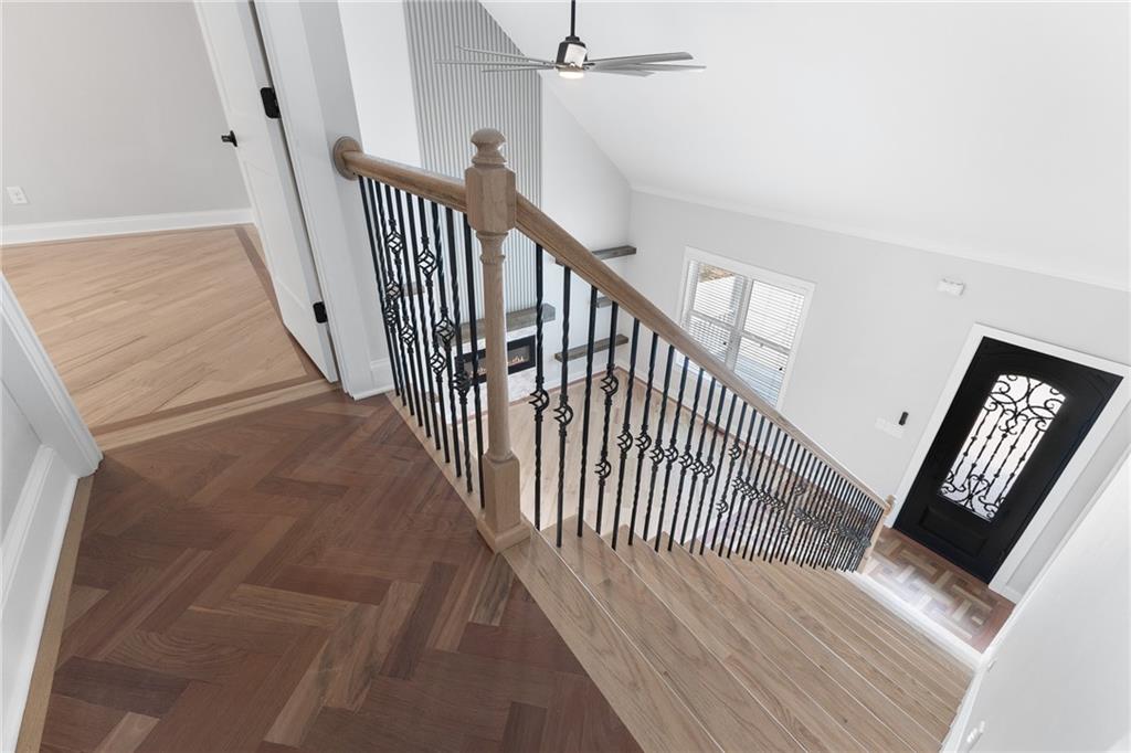1713 Cagle Court Lawrenceville, GA 30045 - Photo 23 of 50 a view of a hallway with wooden floor and stairs