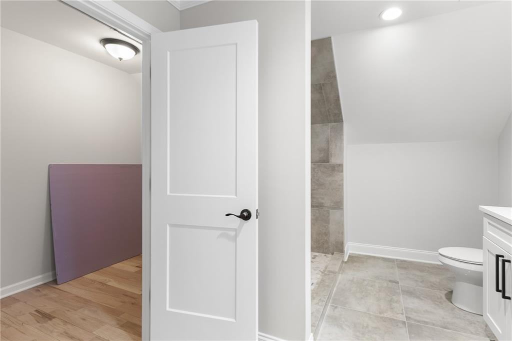 1713 Cagle Court Lawrenceville, GA 30045 - Photo 29 of 50 a bathroom with a toilet and a shower