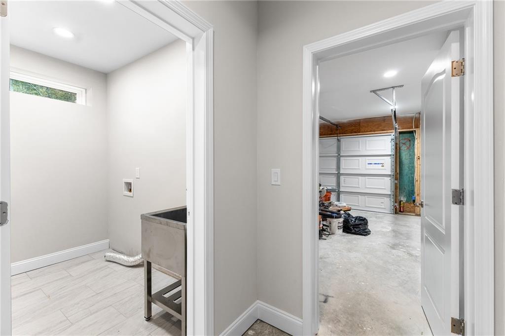 1713 Cagle Court Lawrenceville, GA 30045 - Photo 45 of 50 a view of a hallway with wooden floor and a bathroom