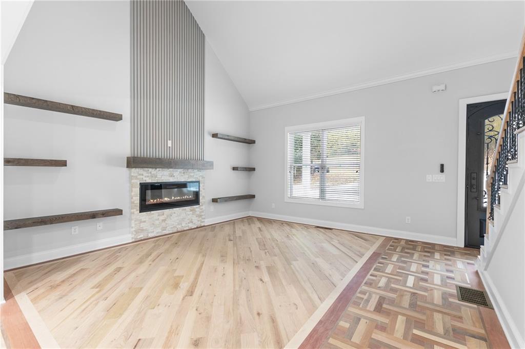 1713 Cagle Court Lawrenceville, GA 30045 - Photo 8 of 50 a view of empty room with wooden floor and fan