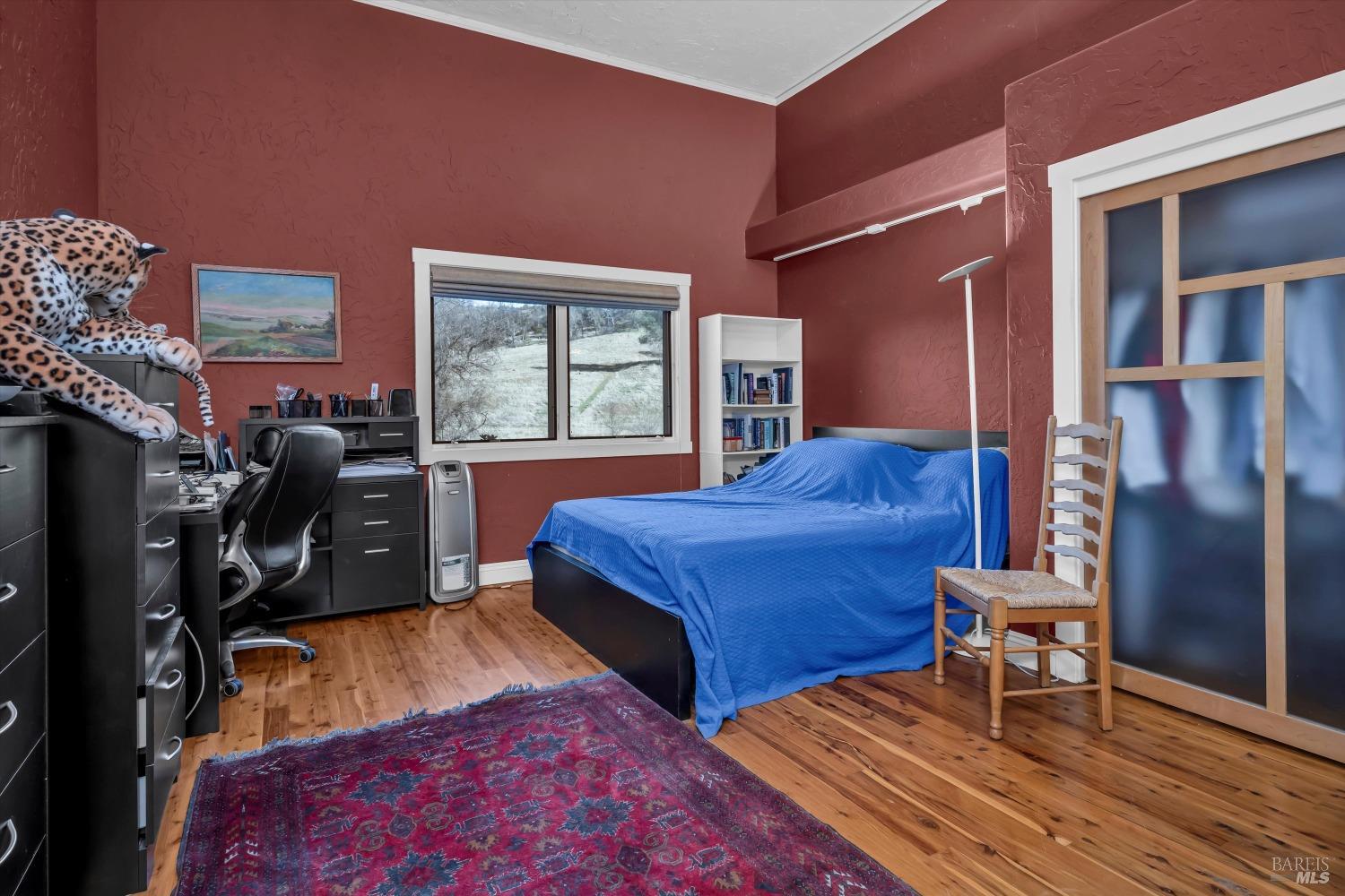 1900 Stagecoach Canyon Road Pope Valley, CA 94567 - Photo 24 of 70 a bedroom with a bed and wooden floor