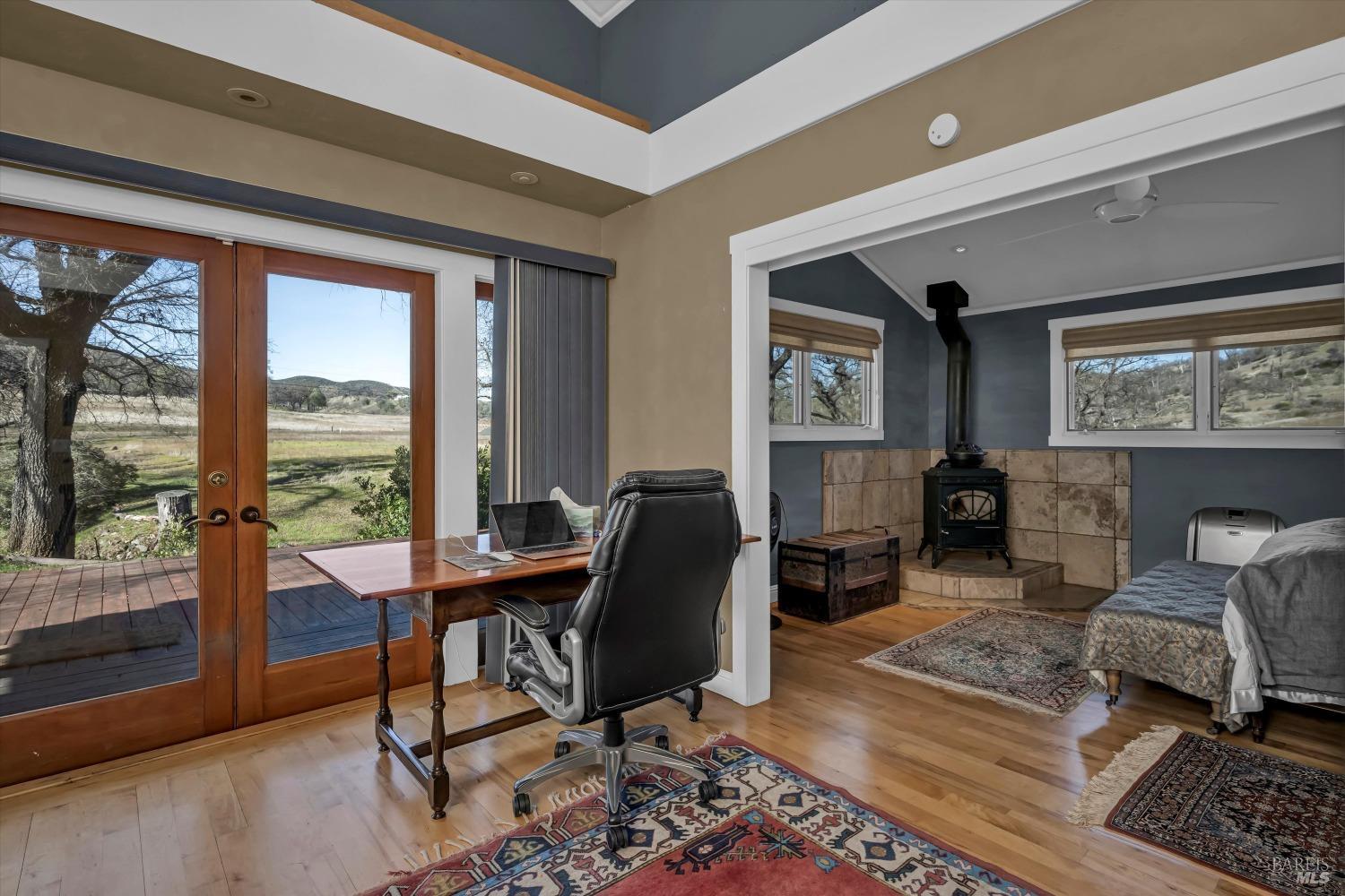 1900 Stagecoach Canyon Road Pope Valley, CA 94567 - Photo 27 of 70 Office/sitting room area off the bedroom suite. Fitted with french doors that offer gorgeous seasonal views of the meadow and hills beyond. There is a deck outside for outdoor enjoyment, or access to a quick dip in the pool and spa.