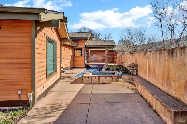 a view of a balcony with wooden floor and fence