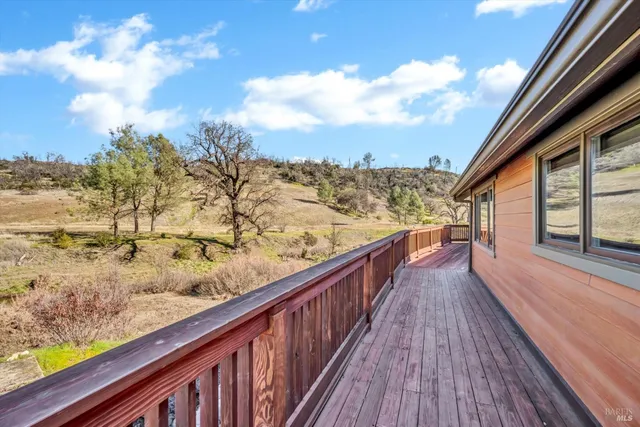 a view of a balcony with wooden fence