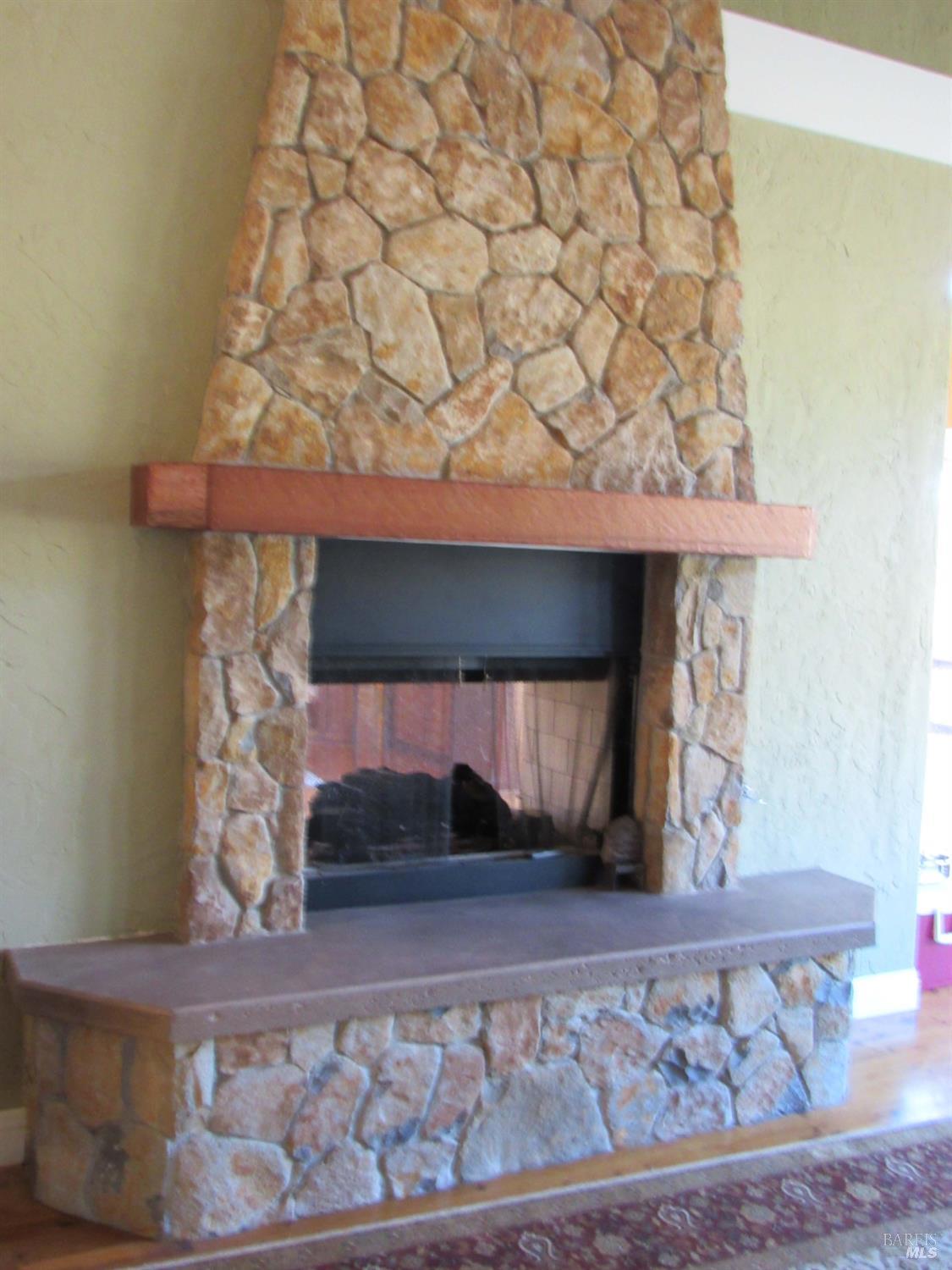 1900 Stagecoach Canyon Road Pope Valley, CA 94567 - Photo 7 of 70 a view of a fireplace in a room