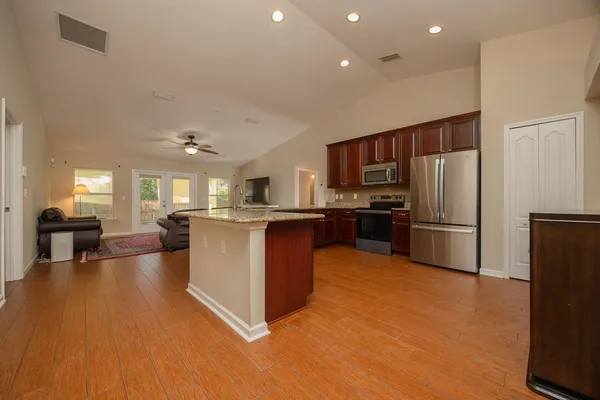 a kitchen with stainless steel appliances a refrigerator and a stove top oven