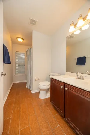 a spacious bathroom with a sink and a mirror