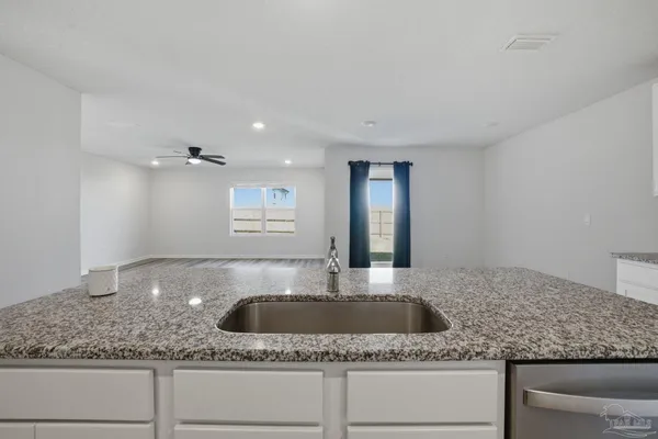 a kitchen with granite countertop a sink and granite counter tops