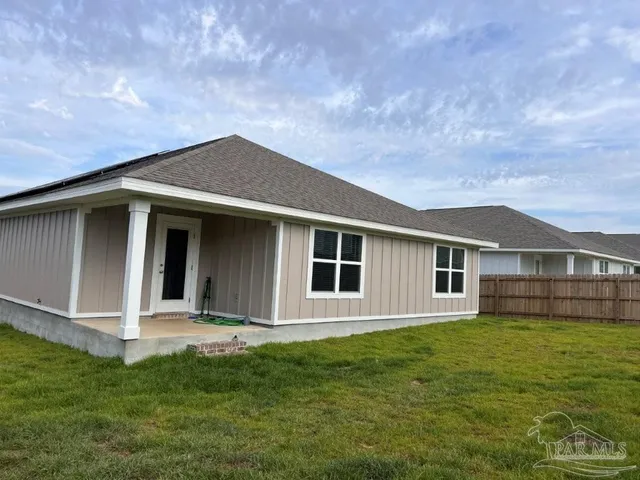 a house with huge green field in front of it
