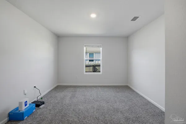 a view of an empty room and a window