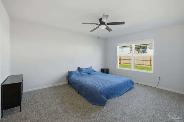 a bed room with a bed and a window