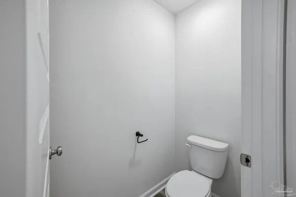 a white toilet sitting next to a shower