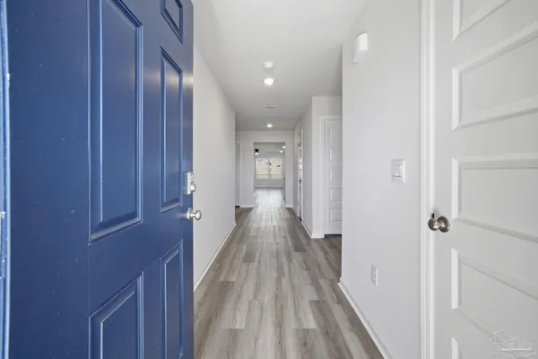 a view of hallway with wooden floor