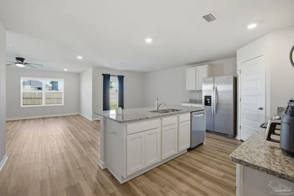 a kitchen with a sink microwave and refrigerator