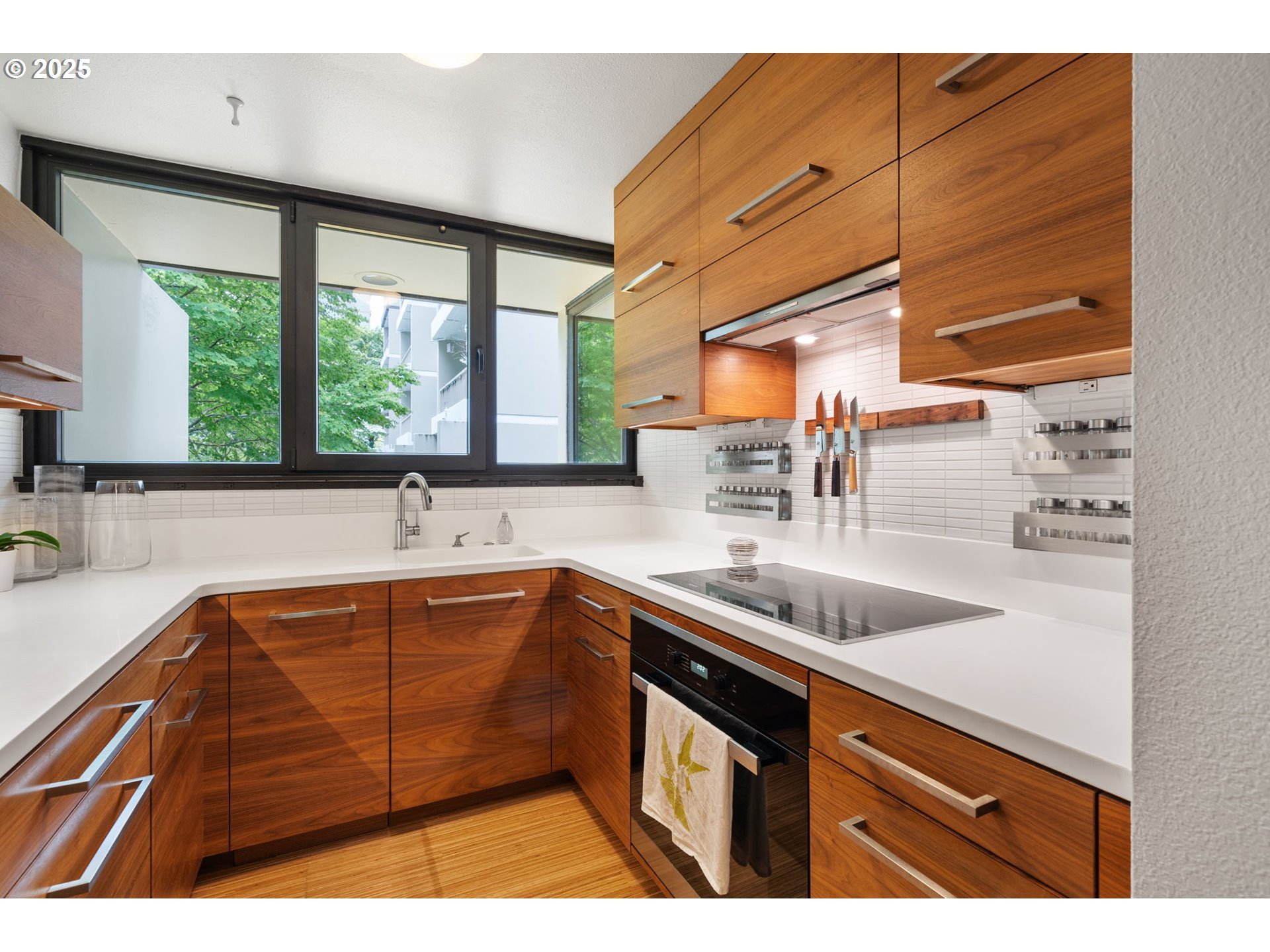 255 Southwest Harrison Street, Unit TH5 Portland, OR 97201 - Photo 17 of 40 a kitchen with a sink stove and cabinets
