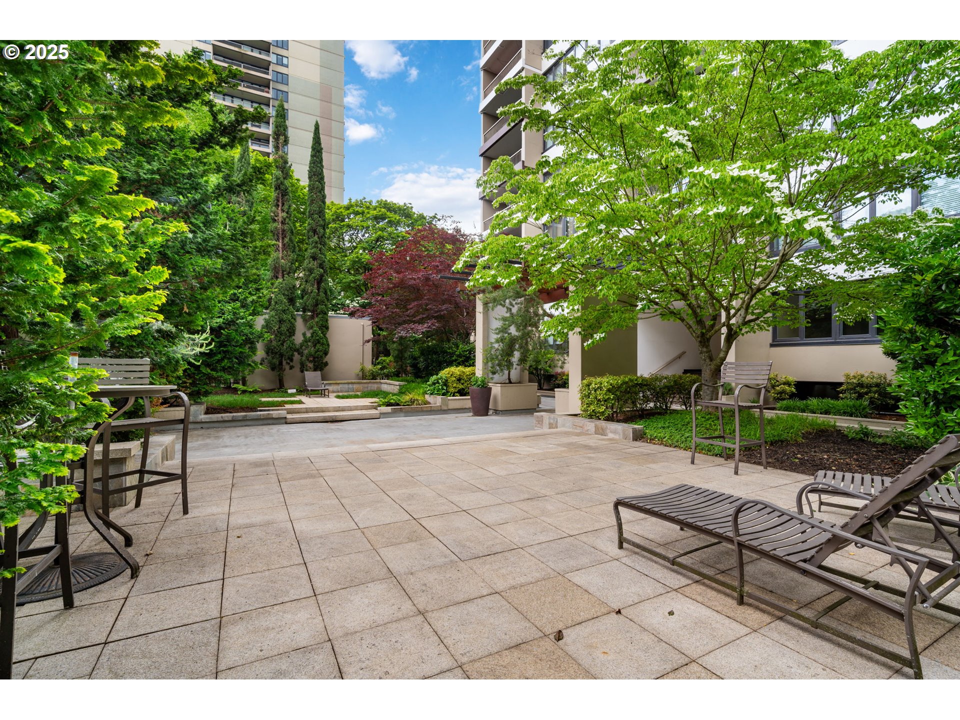 255 Southwest Harrison Street, Unit TH5 Portland, OR 97201 - Photo 2 of 40 a view of a patio with table and chairs and potted plants
