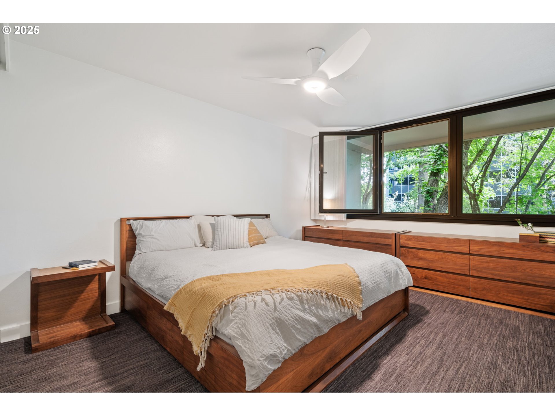 255 Southwest Harrison Street, Unit TH5 Portland, OR 97201 - Photo 24 of 40 a bedroom with a bed and a large window