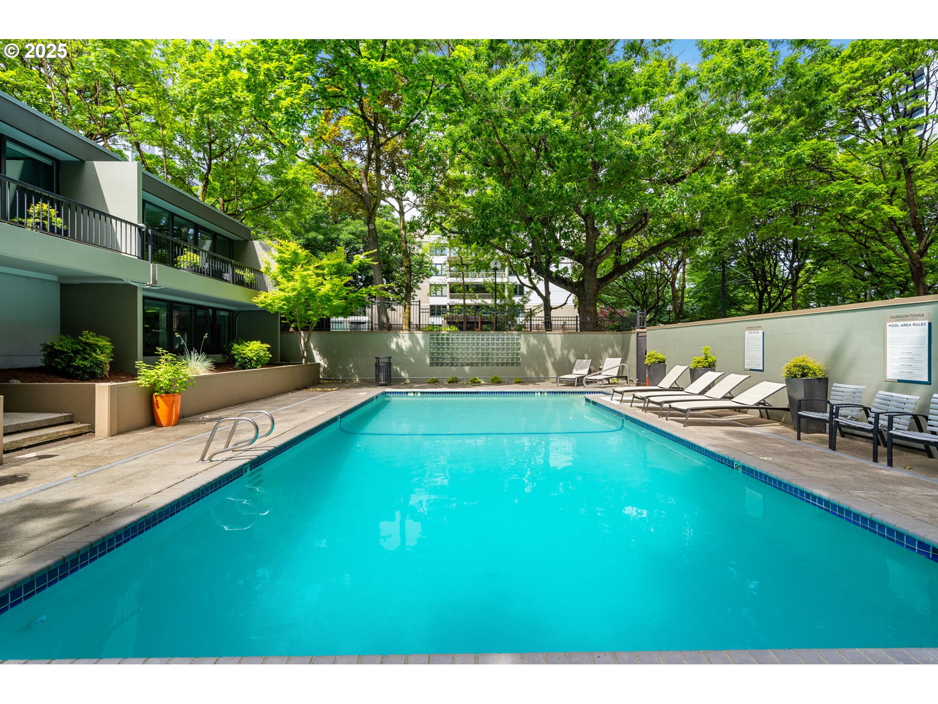 255 Southwest Harrison Street, Unit TH5 Portland, OR 97201 - Photo 32 of 40 a swimming pool with outdoor seating and yard