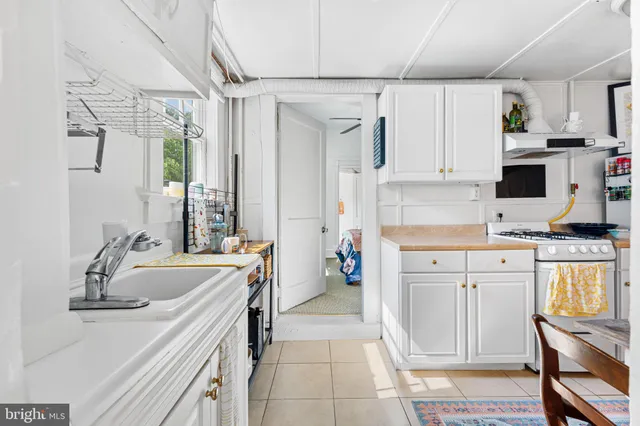 a kitchen with a sink stove and refrigerator