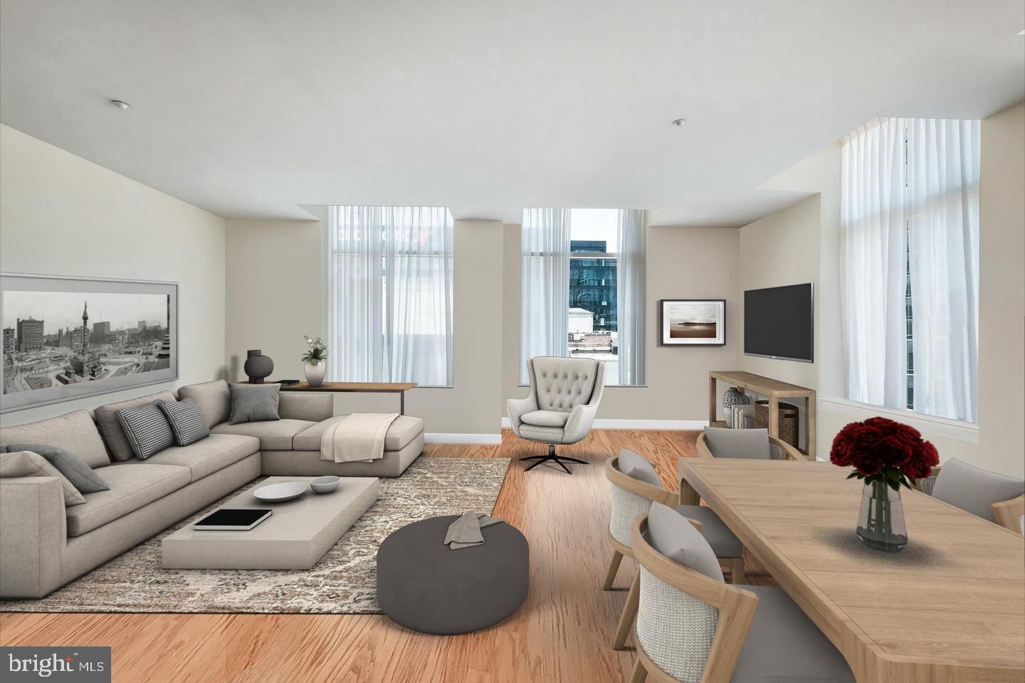 23 South 23rd Street, Unit 6C Philadelphia, PA 19103 - Photo 1 of 12 a living room with furniture and a flat screen tv