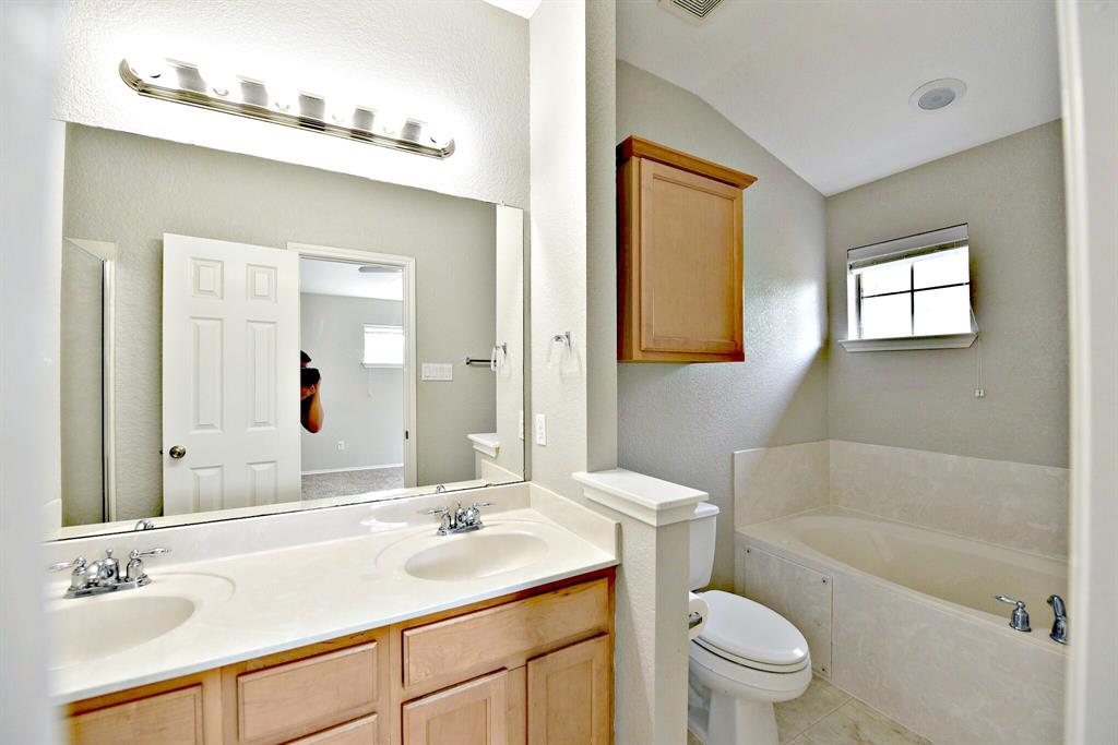 14815 Avery Ranch Boulevard, Unit 702 Austin, TX 78717 - Photo 12 of 19 Bathroom with a bath, a sink, double vanity, and toilet
