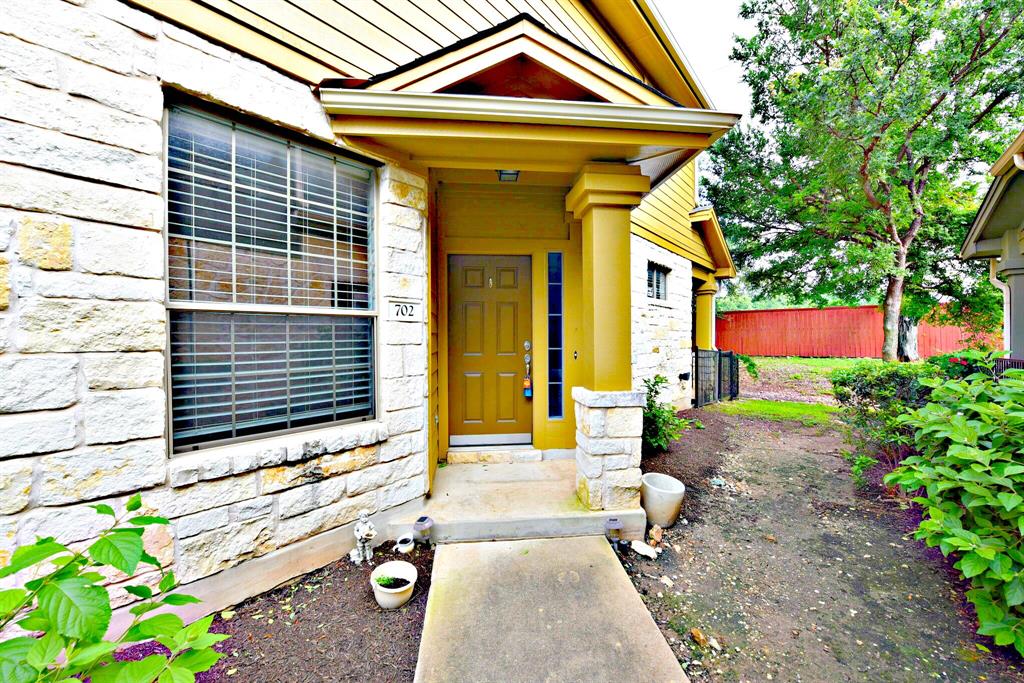 14815 Avery Ranch Boulevard, Unit 702 Austin, TX 78717 - Photo 3 of 19 Property entrance with stone siding and fence